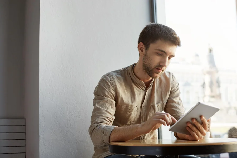 A man browsing on his tablet.
